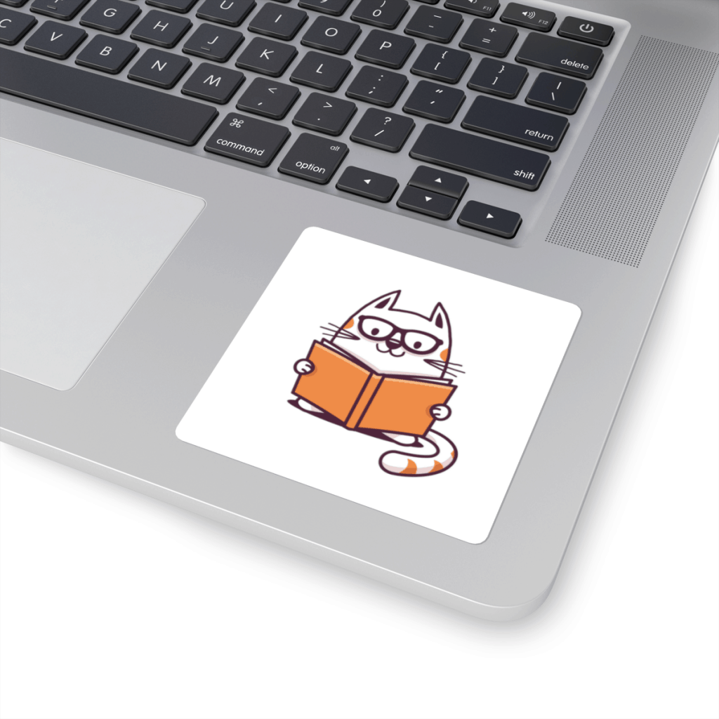A square-shaped sticker with a white background. In its center is an image of a cat reading a book.