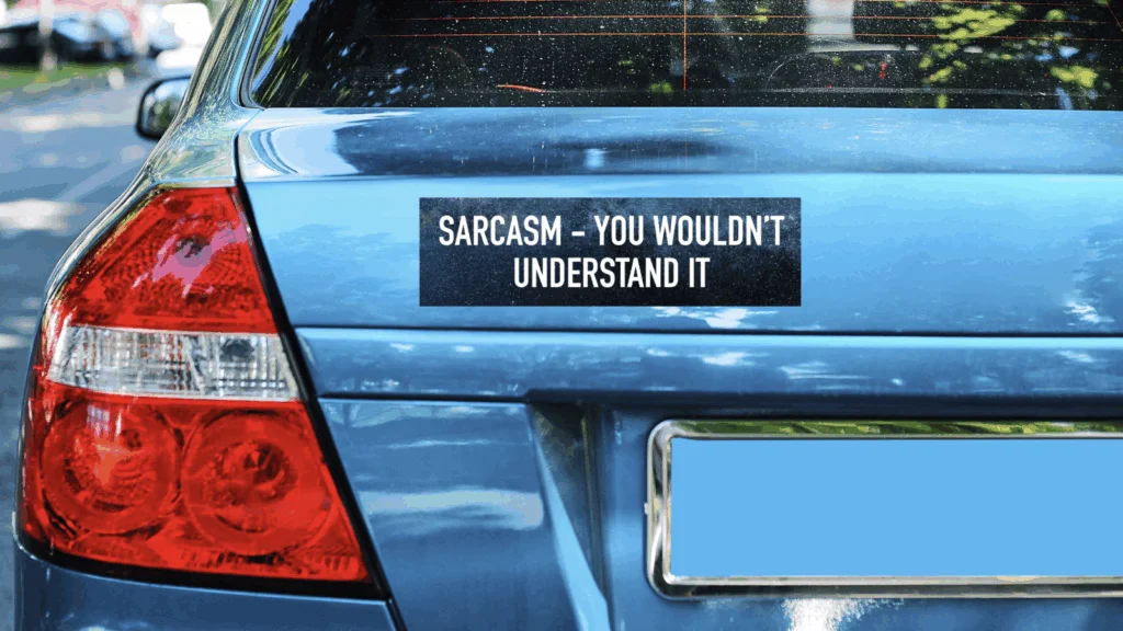 A blue car's rear with a bumper sticker that reads "Sarcasm - You wouldn't understand it."