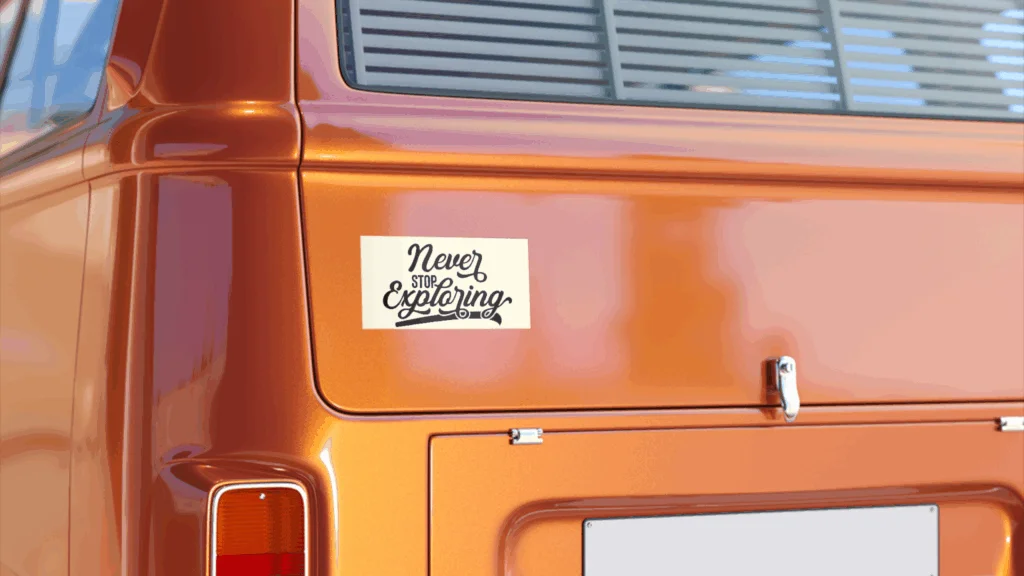 Orange vintage van with a bumper sticker reading "Never Stop Exploring".