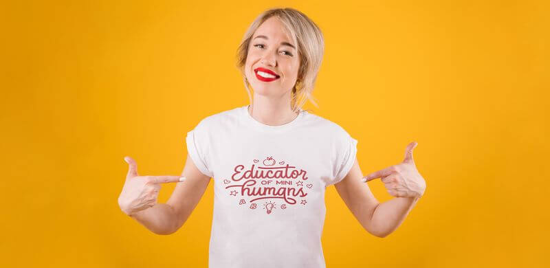 A model wears a t-shirt that says Educator of mini humans.