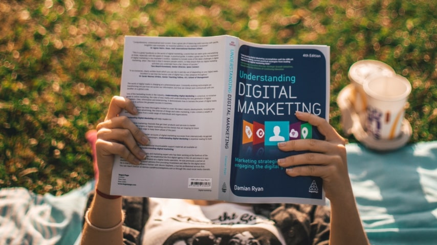 A person reading a book on digital marketing.
