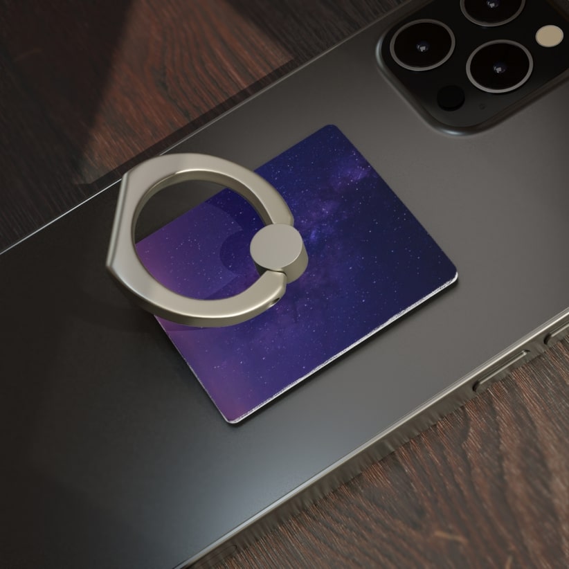 A photo of the back of a phone with a metallic ring holder.