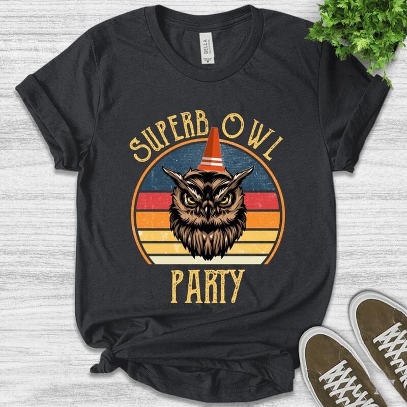 A black shirt with an image of an owl and the text "Superb Owl" printed on it.