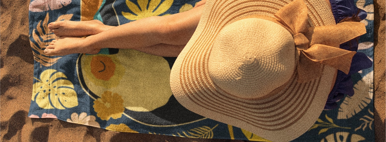 Top view of a woman wearing a straw hat on a beach