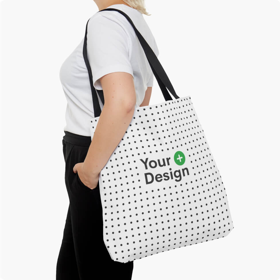 A mockup of a woman holding a tote bag on her shoulder.