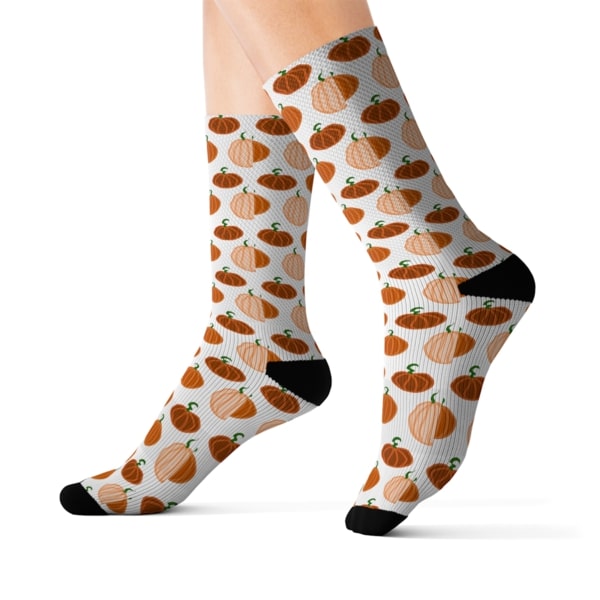 White socks with a repeat pattern of small, orange pumpkins.