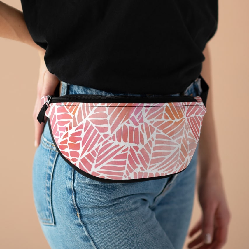 A woman wearing a pink and white fanny pack.