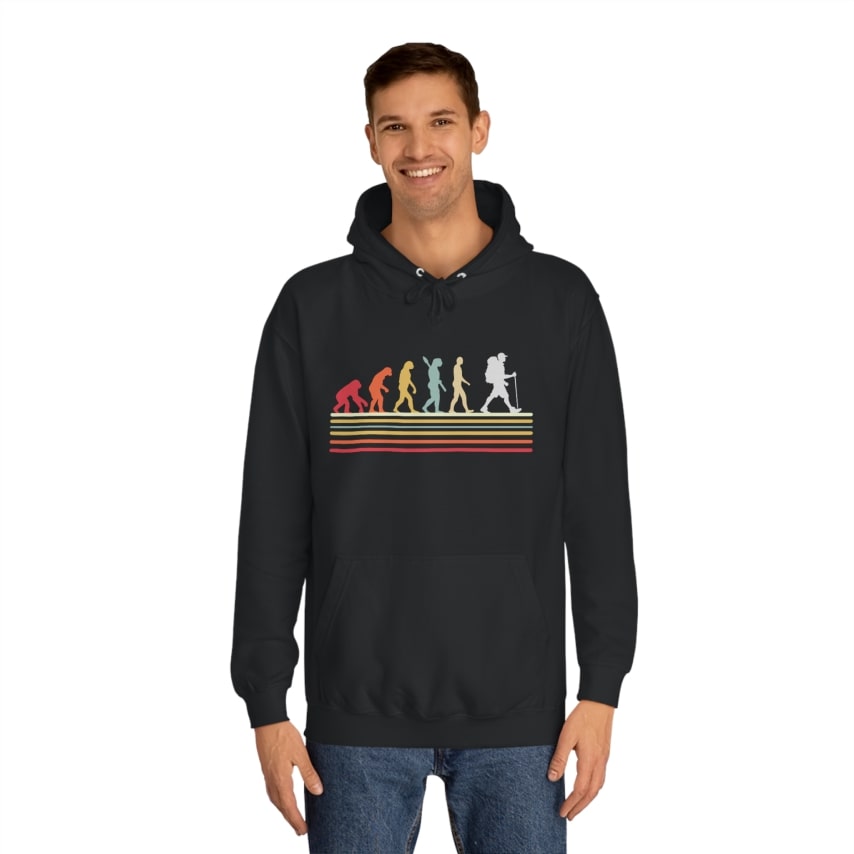 A man wearing a black hoodie with a colorful evolution print on it.