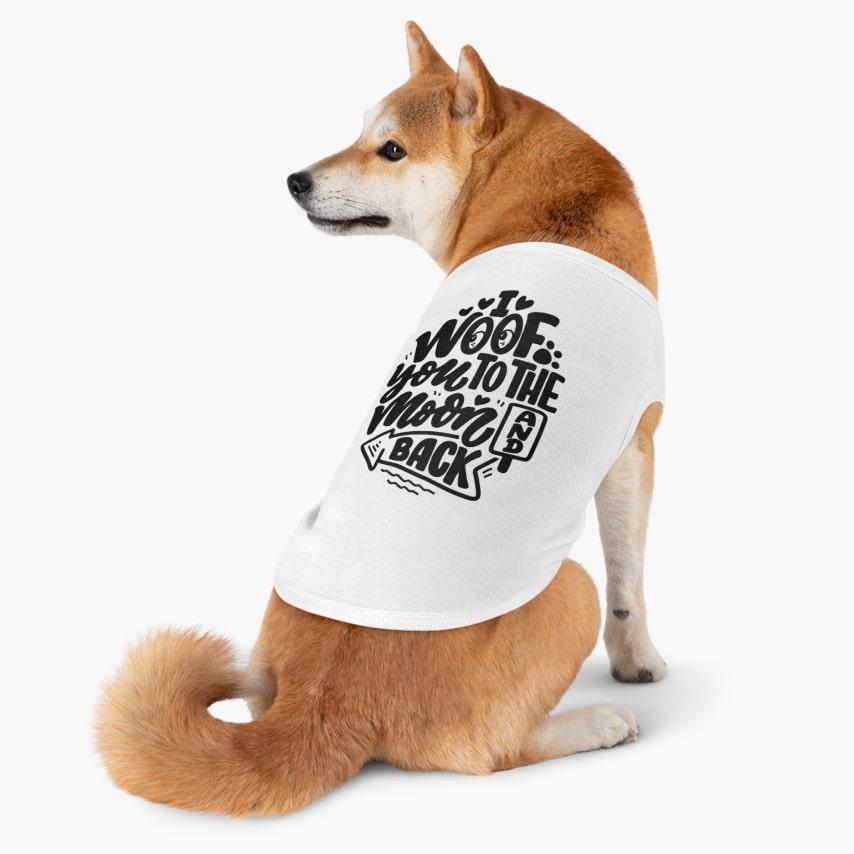 A Shiba Inu wearing a white t-shirt that says "I Woof You to the Moon and Back".