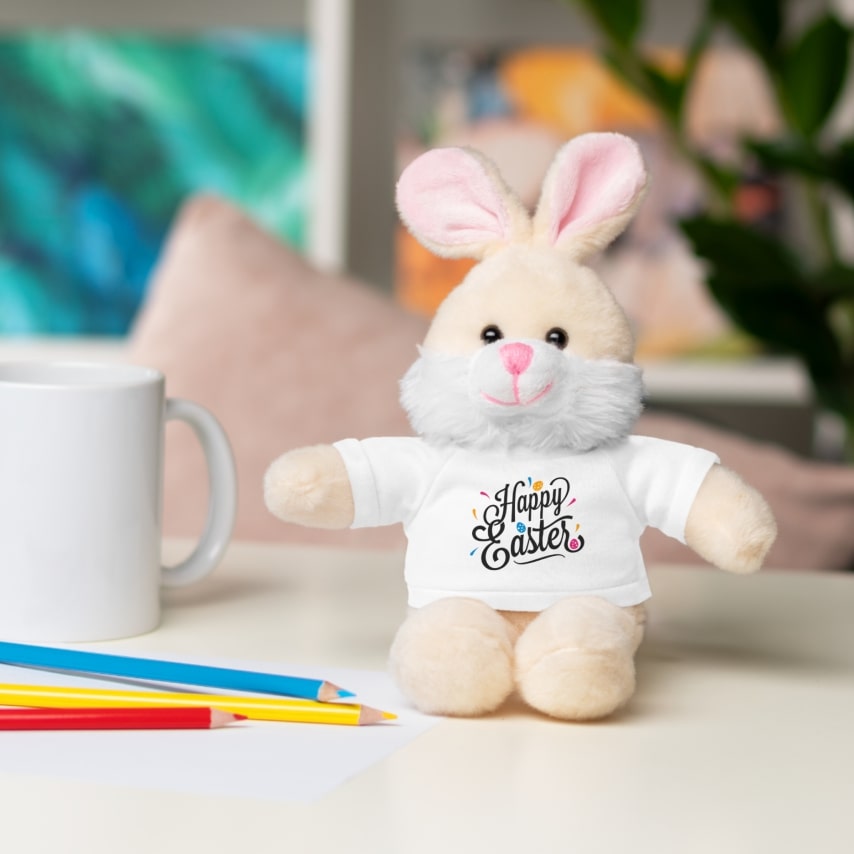 A stuffed rabbit with a white Happy Easter t-shirt.