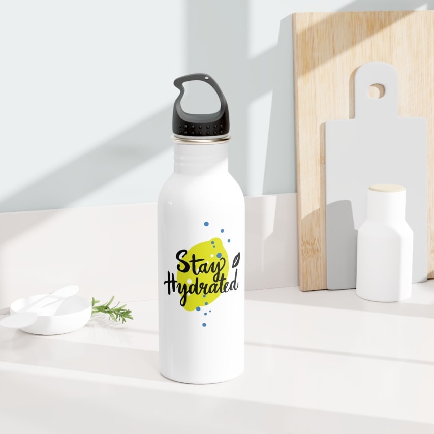 A white water bottle with a Stay Hydrated print on it sitting on the countertop.
