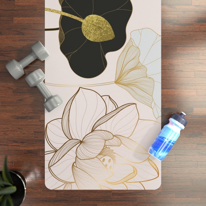 A top view of a floral yoga mat with a water bottle and dumbbells next to it.