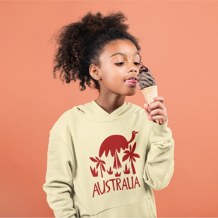 A girl enjoying ice-cream in a custom hoodie with palms, an emu, and Australia written on it