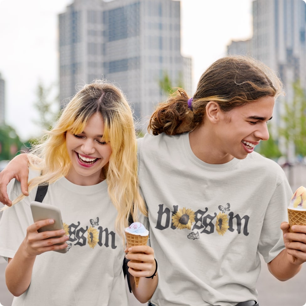 A man and a woman enjoying ice cream in white t-shirts with the word "blossom" on them