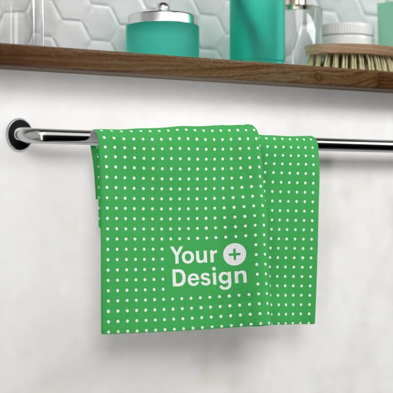 Bath towel with a “Your Design Here” sign hanging in a bathroom.