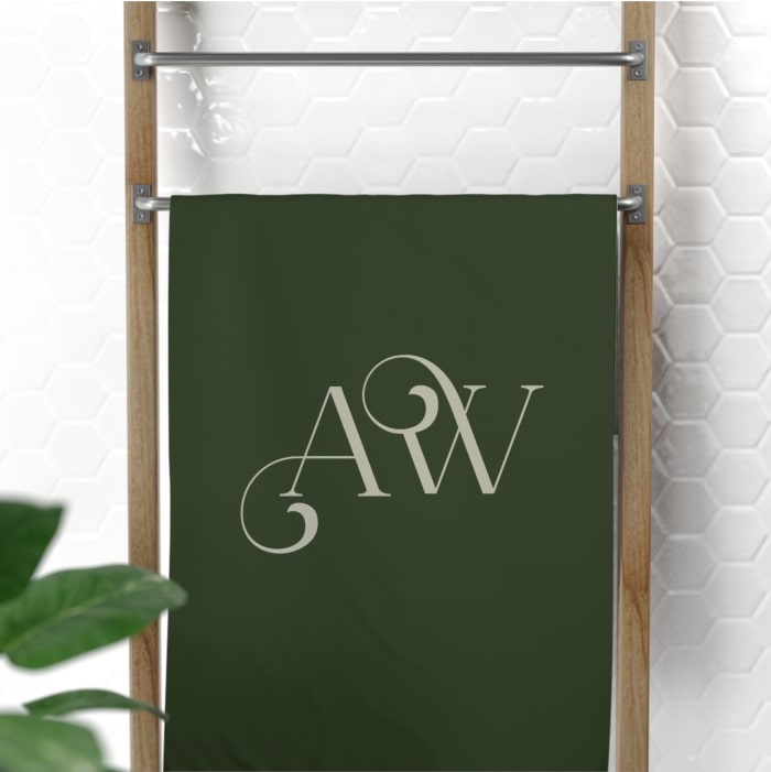 A custom hand towel with the letters “A. W.” printed on it.