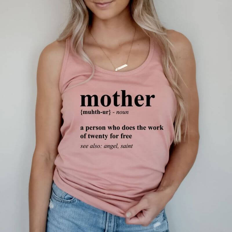 Woman posing in a tank top that has a clever definition of a mother printed on it