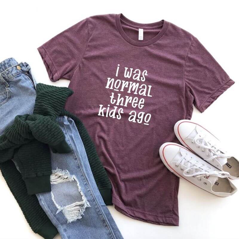 Display of an outfit with a red t-shirt that says "I was normal three kids ago"
