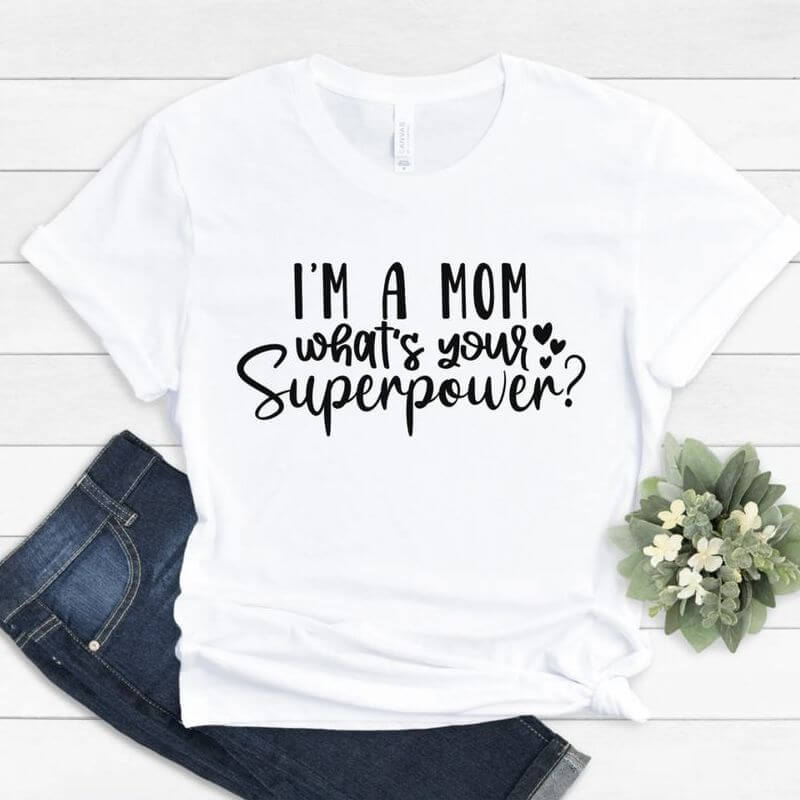Displayed outfit with a white t-shirt that says "I'm a mom, what's your superpower?"