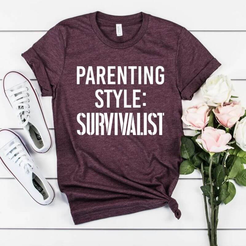 Displayed outfit with a red shirt that says "Parenting style: Survivalist"