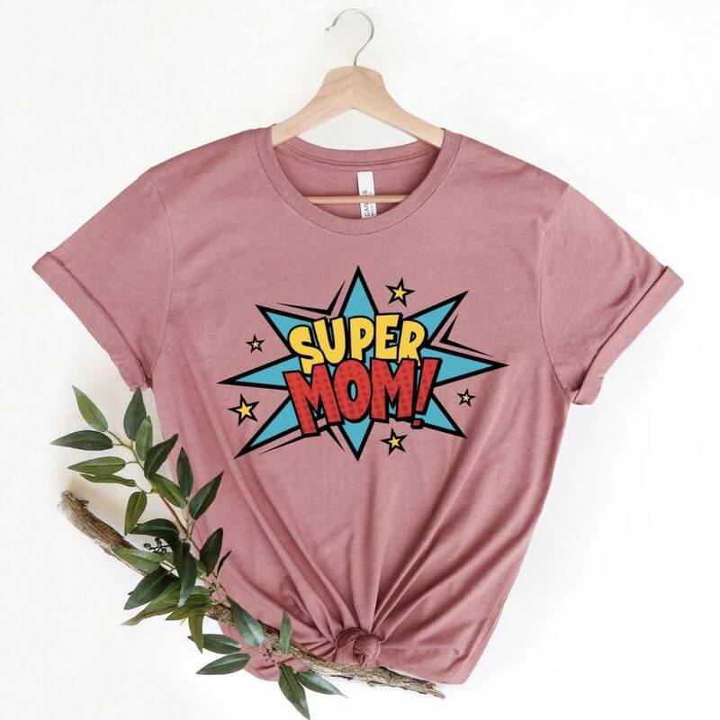 A pink t-shirt with a comic-like design that says "Super Mom"