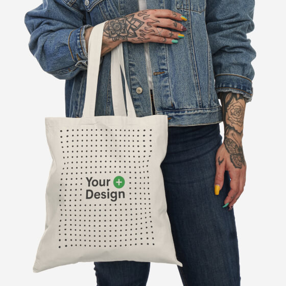 A mockup of a woman holding a tote bag on her hand.