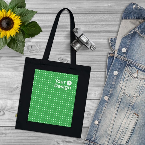 A mockup of an organic tote bag on a wooden floor.