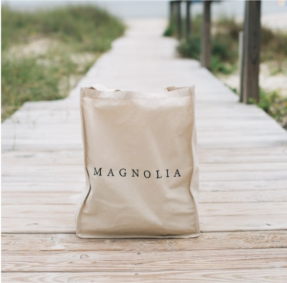 An image of a personalized tote bag on the beach.
