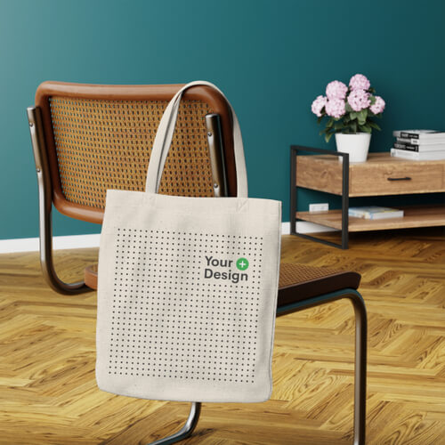 A mockup of a polyester tote bag hanging on a chair.