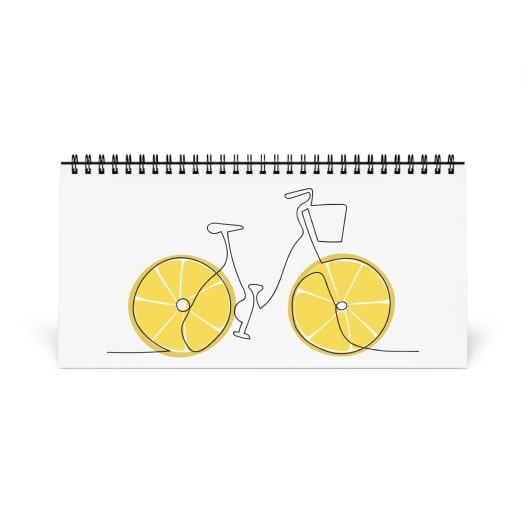 Desk calendar with line art bicycle that has lemon slices for wheels.