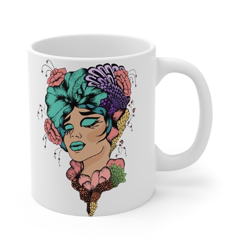 White ceramic mug with a stylized and colourful image of a woman's face.