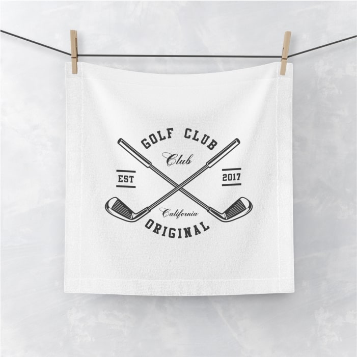 White towel with a logo containing the text “Golf Club Original: Club California. EST 2017” and an image of crossed golf clubs.