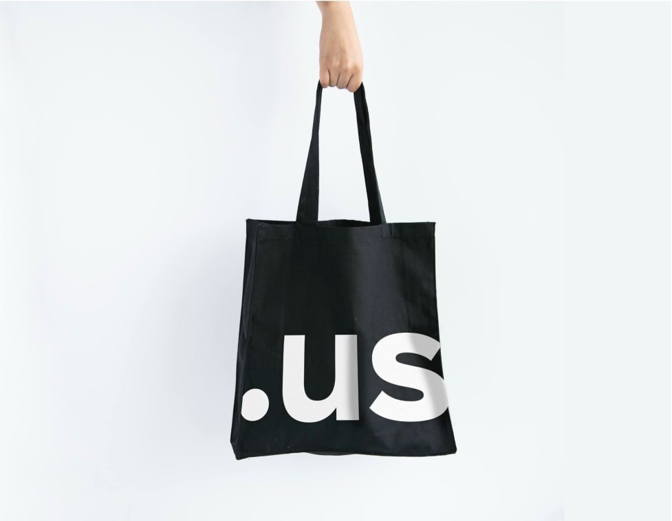 A picture of a black tote bag with white lettering on it.