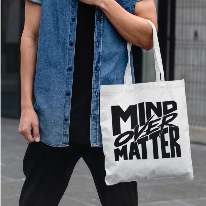 An image of a man holding a custom tote with text.