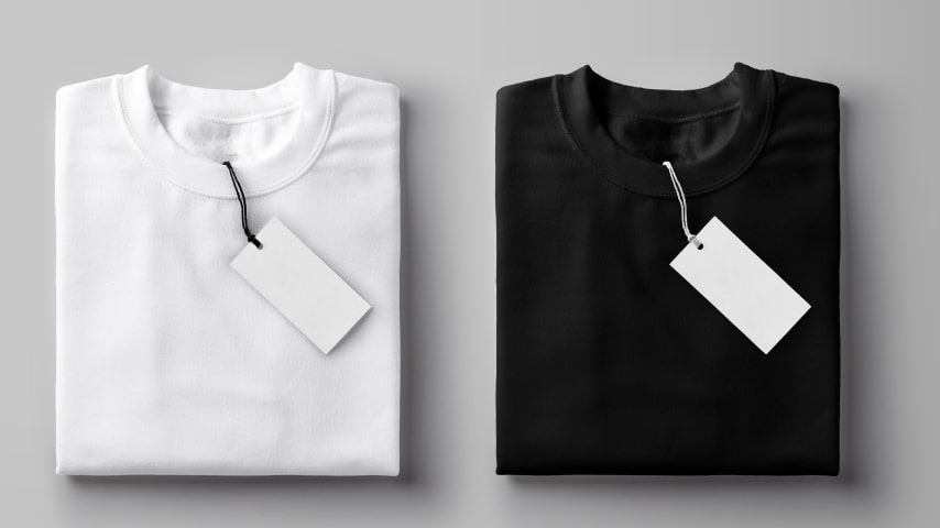 Folded black and white t-shirts with blank price tags.
