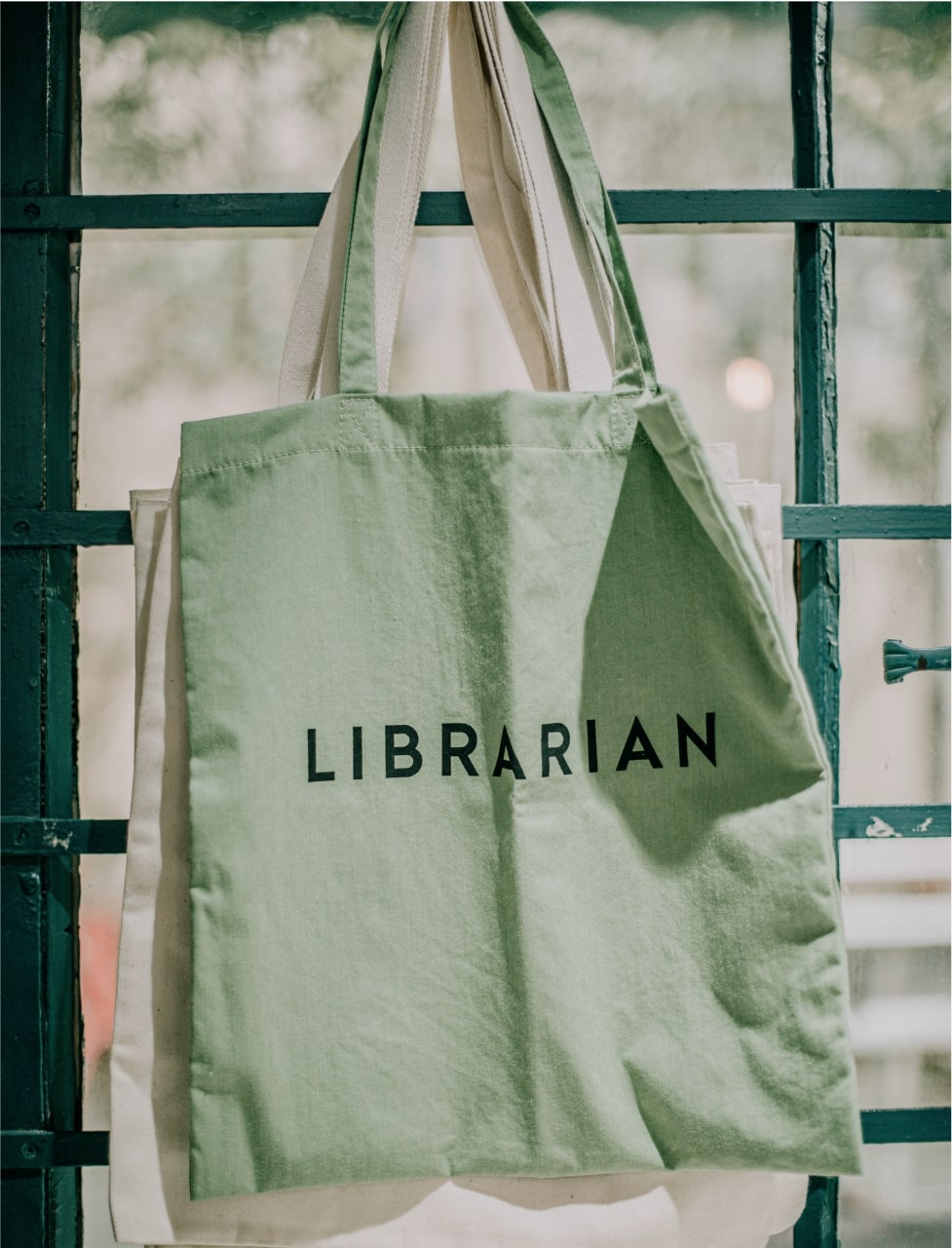 An image of a personalized tote bag in green with the word “Librarian” on it.