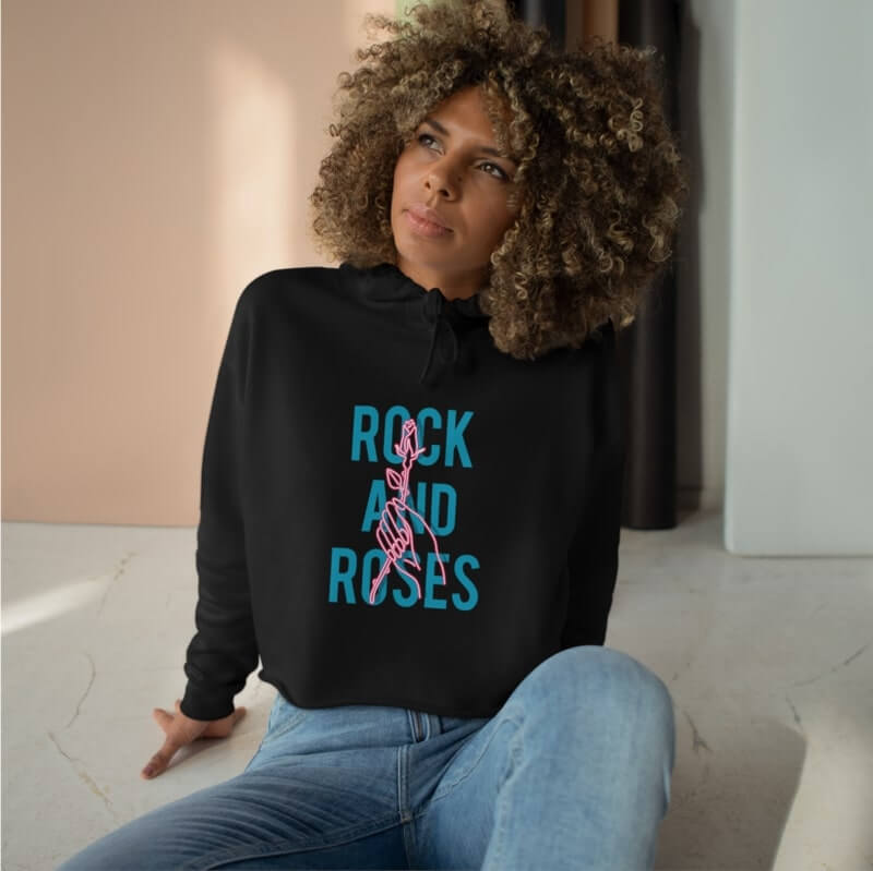 An image of a woman wearing a black custom crop top with illustrated text on it.