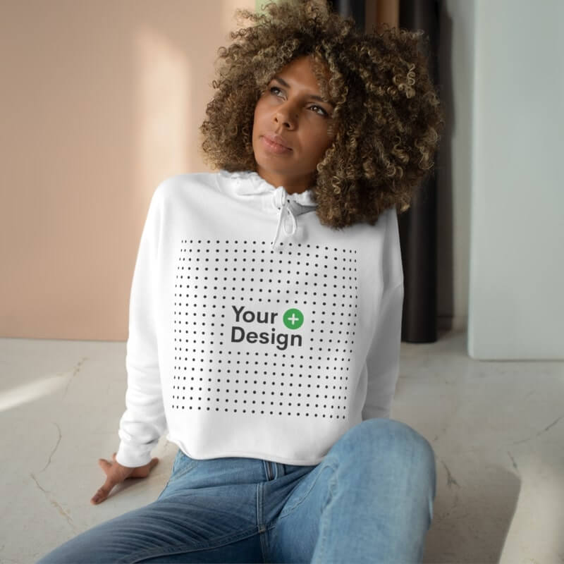 A mockup image of a woman wearing a custom crop top with a design placeholder.
