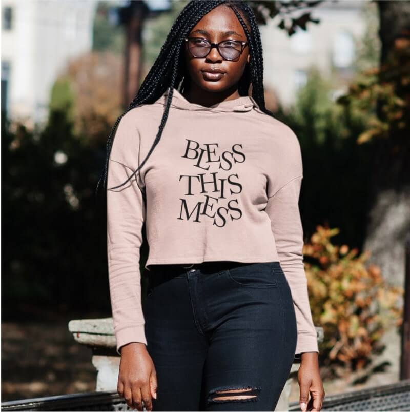 An image of a woman wearing a beige custom crop top with text on it.
