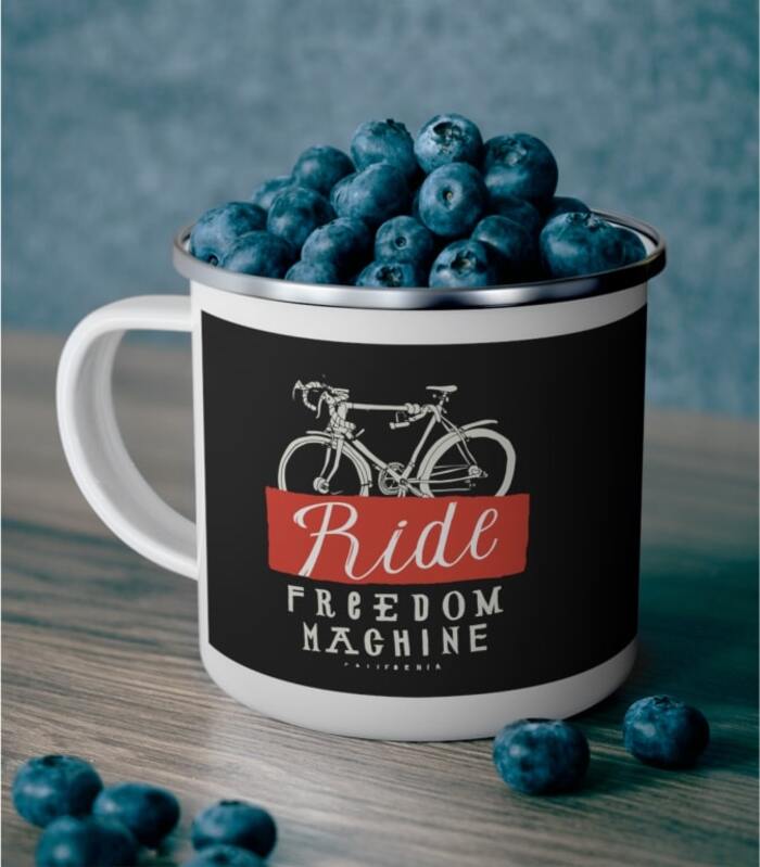 Blueberry-filled custom enamel mug with an image of a bicycle and the text “Ride Freedom Machine.”