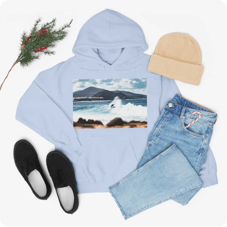 Light blue hoodie with a photo of a person surfing in the ocean printed on the front.