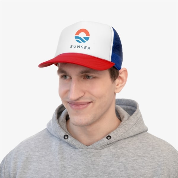 A man wearing a custom trucket hat with a company logo.
