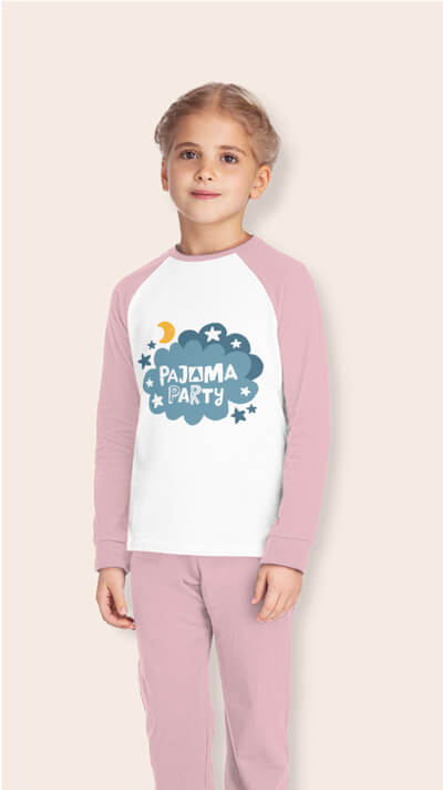 Girl in a pink and white pajama set with the text “Pajama Party” and a design of clouds and stars on the front of the shirt.