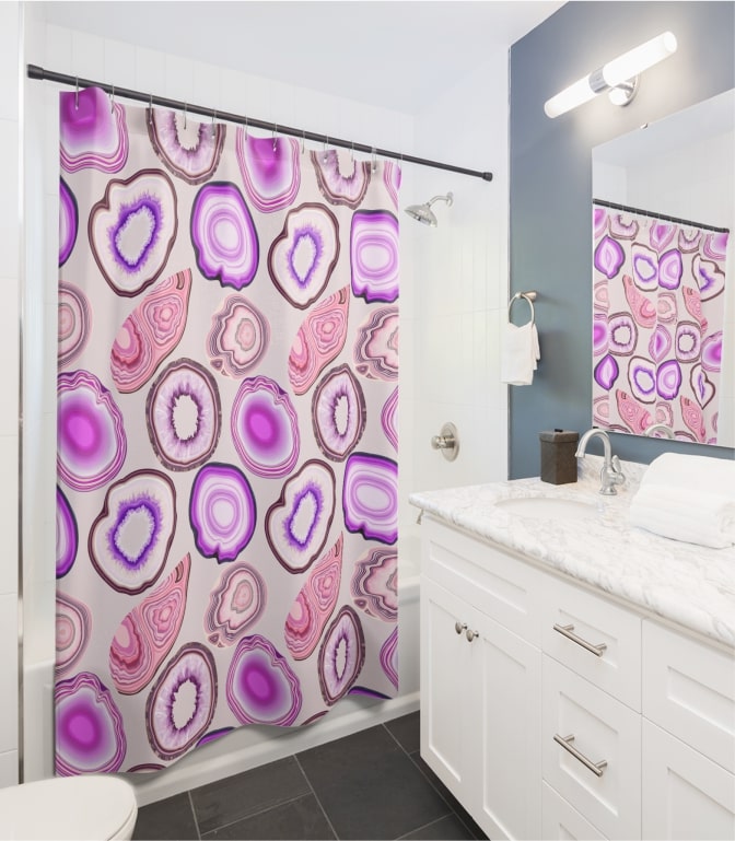 An image of a custom shower curtain with a light-colored abstract design.