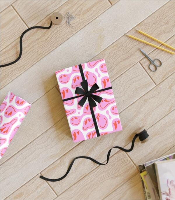 A mockup image of a gift box in custom wrapping paper laying on the floor.