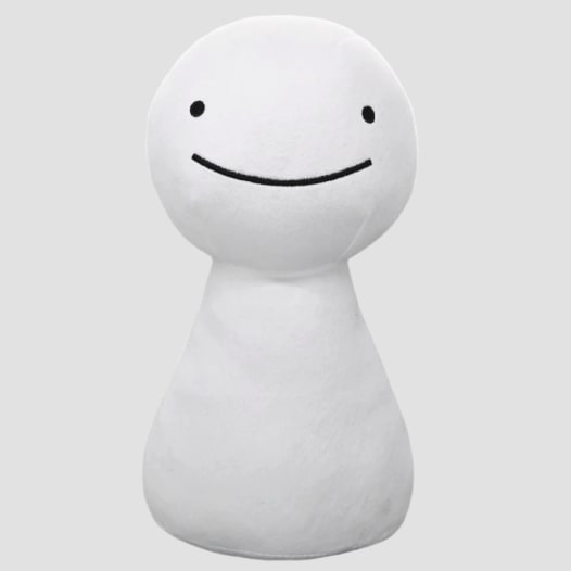 A plushie of a little white humanoid creature with a wide smile.