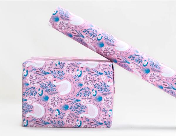 A mockup image of a gifts box and a roll of custom wrapping paper.