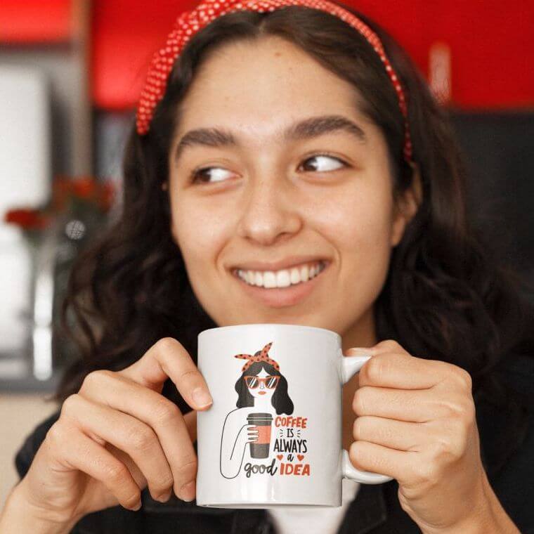 A woman holds a mug with an illustration of a woman and a quote about coffee.