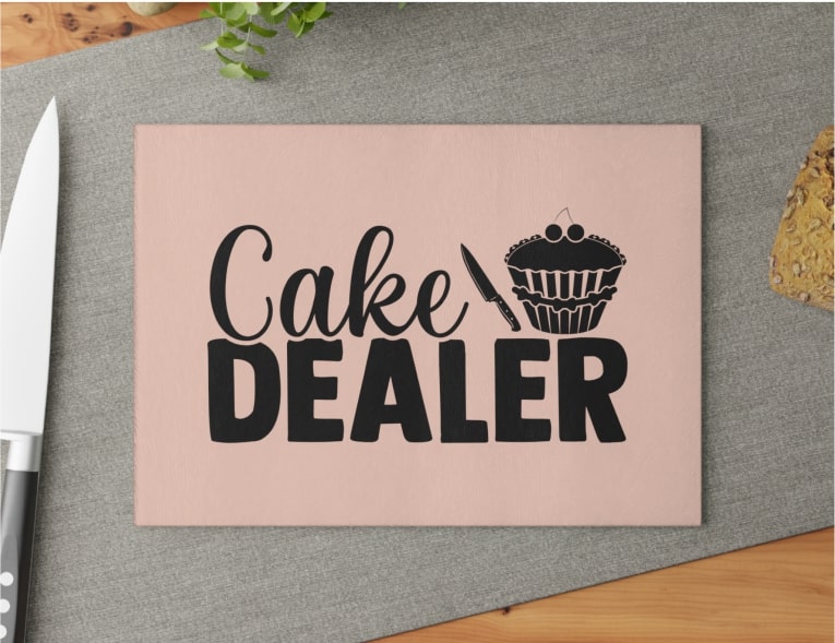 Top view of a cutting board that says "Cake Dealer"