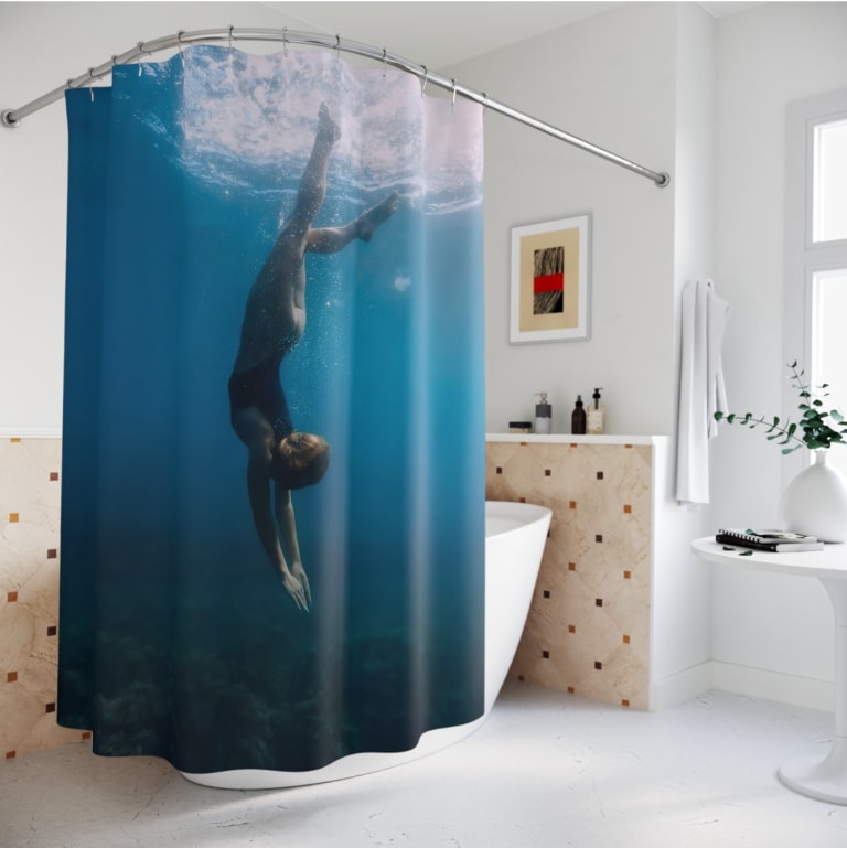 An image of a custom shower curtain with a diver print.